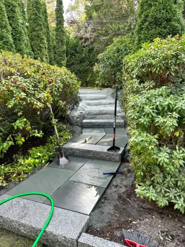 Granite slab steps through garden beds