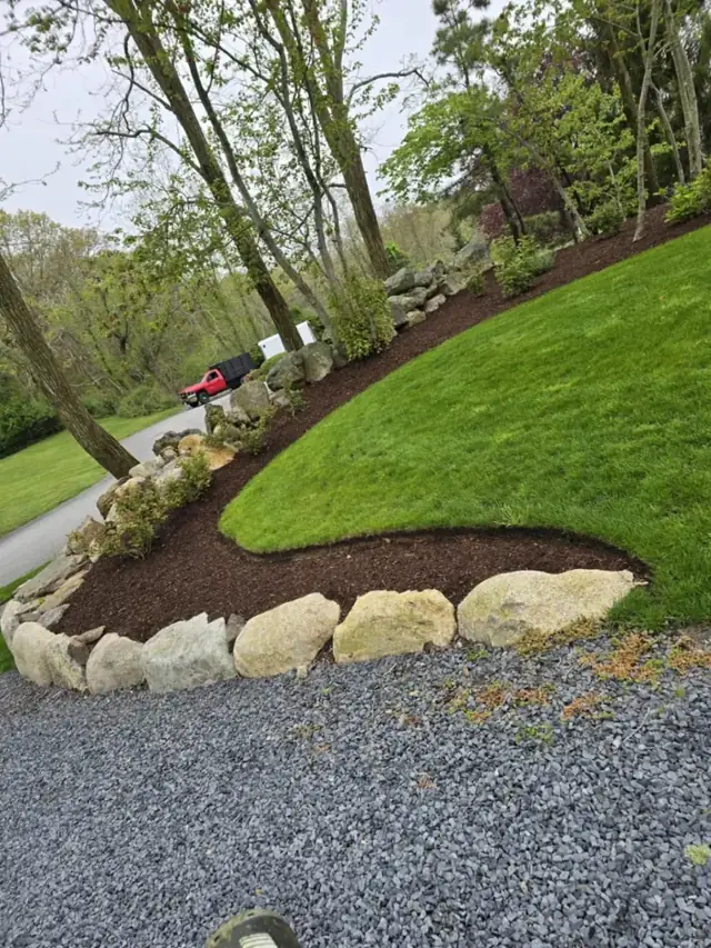 Boulder edging along a gravel drive